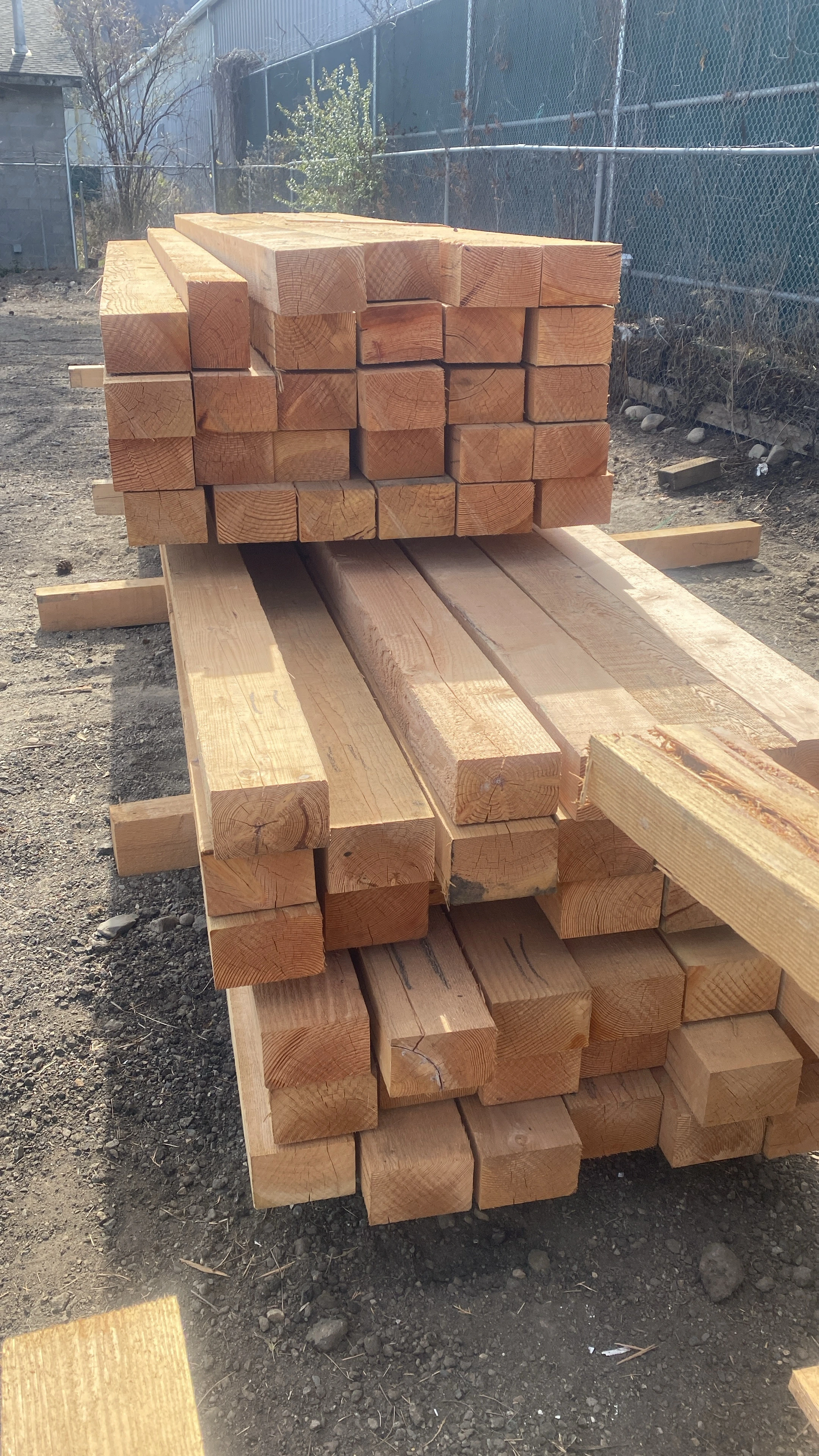 Large stack of fresh Douglas Fir beams and posts in the yard